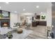 Open-concept living space with a fireplace, modern decor, and seamless flow to the kitchen and dining area at 3288 Tarragon Dr, Decatur, GA 30034