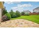 Spacious backyard featuring a stone patio, lush greenery and mature landscaping at 5066 Healey Dr, Smyrna, GA 30082