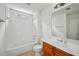Bright bathroom featuring tiled shower and tub, window, and vanity with sink at 5066 Healey Dr, Smyrna, GA 30082