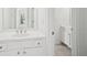Bright white bathroom features a white vanity and tiled floors at 5066 Healey Dr, Smyrna, GA 30082