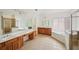 Well-lit bathroom with dual sinks and a glass shower at 5066 Healey Dr, Smyrna, GA 30082