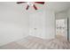 Bright bedroom features neutral walls, patterned carpet, ceiling fan, and closet for ample storage at 5066 Healey Dr, Smyrna, GA 30082