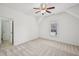 Well-lit bedroom with neutral carpet, a ceiling fan, and a window view of the neighborhood at 5066 Healey Dr, Smyrna, GA 30082