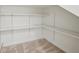 Walk-in closet with carpet and adjustable shelving for customizable storage solutions at 5066 Healey Dr, Smyrna, GA 30082