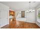 A dining room features hardwood floors, and is open to the Gathering room and a built-in desk area at 5066 Healey Dr, Smyrna, GA 30082
