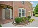 Inviting brick home entrance with a stylish front door, lush landscaping, and a two-car garage at 5066 Healey Dr, Smyrna, GA 30082