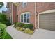 Brick home featuring a landscaped front, concrete walkway, and a convenient two-car garage at 5066 Healey Dr, Smyrna, GA 30082