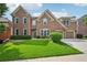 Charming two-story brick home with a lush green lawn and attached two-car garage at 5066 Healey Dr, Smyrna, GA 30082