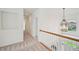 Upstairs hallway featuring a decorative light fixture and stairway view at 5066 Healey Dr, Smyrna, GA 30082