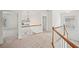 Upstairs hallway showcases railing and view to rooms at 5066 Healey Dr, Smyrna, GA 30082