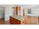 The kitchen features a center island with granite countertops, wooden cabinets and hardwood floors at 5066 Healey Dr, Smyrna, GA 30082