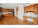 A spacious kitchen features wooden cabinets, granite countertops, a center island, built-in desk and stainless appliances at 5066 Healey Dr, Smyrna, GA 30082