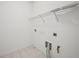 Clean, utilitarian laundry room with tile flooring and utility connections at 5066 Healey Dr, Smyrna, GA 30082