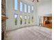 Bright and airy living room with tall windows, carpeted floors, and views into the kitchen at 5066 Healey Dr, Smyrna, GA 30082