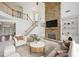 Elegant living room with a stone fireplace and built-in cabinets, featuring a staircase and open layout at 5066 Healey Dr, Smyrna, GA 30082