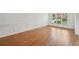 Bright living room with hardwood floors and white walls, natural light from the window at 5066 Healey Dr, Smyrna, GA 30082