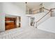 Spacious living room with a staircase, carpeted floors, and views into the kitchen at 5066 Healey Dr, Smyrna, GA 30082