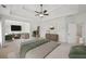 Main bedroom suite showcasing tray ceiling, fan, and sitting area at 5066 Healey Dr, Smyrna, GA 30082