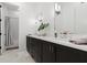 Modern bathroom featuring dual sinks with dark vanity, quartz counters, and a separate tub/shower at 6640 Avis Walk, Alpharetta, GA 30005
