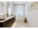 Bright bathroom features a freestanding tub, dual vanity with marble counters, and decorative gold accents at 6640 Avis Walk, Alpharetta, GA 30005