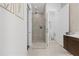 Modern bathroom with glass enclosed shower, marble tile, and dark wood vanity and white countertop at 6640 Avis Walk, Alpharetta, GA 30005