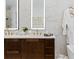 Elegant bathroom boasts dual sinks, marble countertops, a dark wood vanity, and minimalist gold fixtures at 6640 Avis Walk, Alpharetta, GA 30005