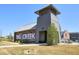 Community entrance features a brick and grey wood building with landscaped grounds and bike racks at 6640 Avis Walk, Alpharetta, GA 30005