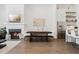 Modern dining area and living room with fireplace featuring stainless steel appliances and open shelving at 6640 Avis Walk, Alpharetta, GA 30005