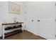 Hallway with hardwood floors, white walls, rustic console table, and modern art at 6640 Avis Walk, Alpharetta, GA 30005