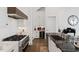 Gourmet kitchen with stainless steel appliances, a wine fridge, and a sleek black countertop at 6640 Avis Walk, Alpharetta, GA 30005