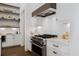 Contemporary kitchen featuring stainless steel appliances, stylish cabinets, and a modern cooktop for cooking at 6640 Avis Walk, Alpharetta, GA 30005