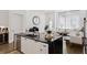 Stylish kitchen featuring a black marble island, stainless steel appliances, and elegant pendant lighting at 6640 Avis Walk, Alpharetta, GA 30005