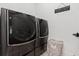 Convenient laundry room equipped with modern washer and dryer, with decorative tile flooring at 6640 Avis Walk, Alpharetta, GA 30005