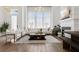Spacious living room with fireplace, modern décor, hardwood floors, and natural light creating a bright and inviting space at 6640 Avis Walk, Alpharetta, GA 30005