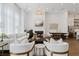 Sophisticated living room featuring a fireplace, elegant seating, tall ceilings, and lots of natural light at 6640 Avis Walk, Alpharetta, GA 30005