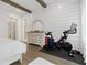 Bedroom features gym equipment, wood beams, and modern farmhouse style at 6640 Avis Walk, Alpharetta, GA 30005