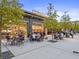 Outdoor dining area featuring tables and seating in front of Halcyon, ideal for community gatherings at 6640 Avis Walk, Alpharetta, GA 30005