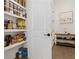 Walk-in pantry with floor to ceiling shelving for ample storage space at 6640 Avis Walk, Alpharetta, GA 30005