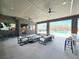 Open-air lounge area near a pool, featuring comfortable seating, a fireplace, and a TV for relaxation and entertainment at 6640 Avis Walk, Alpharetta, GA 30005