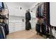 Spacious walk-in closet with custom shelving, built-in dressers, ample storage, and mirrored cabinet doors at 6640 Avis Walk, Alpharetta, GA 30005