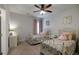 bedroom features two cozy beds with decorative pillows, a ceiling fan, and a writing desk at 7435 Ansley Park Way, Cumming, GA 30028
