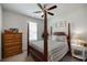 Cozy bedroom with four poster bed, neutral tones and natural light at 7435 Ansley Park Way, Cumming, GA 30028