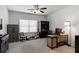 Bedroom featuring a large window, ceiling fan, and ample space for a study area at 7435 Ansley Park Way, Cumming, GA 30028