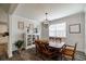 Elegant dining room with wood table, chandelier, and wainscoting at 7435 Ansley Park Way, Cumming, GA 30028
