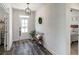 Welcoming entryway with hardwood floors, a bench, decor and view into bedroom at 7435 Ansley Park Way, Cumming, GA 30028