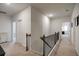 Bright hallway on second floor with carpet flooring and access to multiple bedrooms at 7435 Ansley Park Way, Cumming, GA 30028
