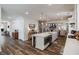 Modern kitchen island with counter seating and open layout to living area at 7435 Ansley Park Way, Cumming, GA 30028
