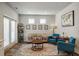 Inviting living room with comfortable seating, accent rug, and natural light at 7435 Ansley Park Way, Cumming, GA 30028