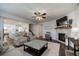 Open-concept layout with a stone fireplace, connecting the living room and kitchen area at 7435 Ansley Park Way, Cumming, GA 30028