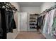 Spacious walk-in closet featuring built-in shelving for shoes, clothes, and accessories at 7435 Ansley Park Way, Cumming, GA 30028